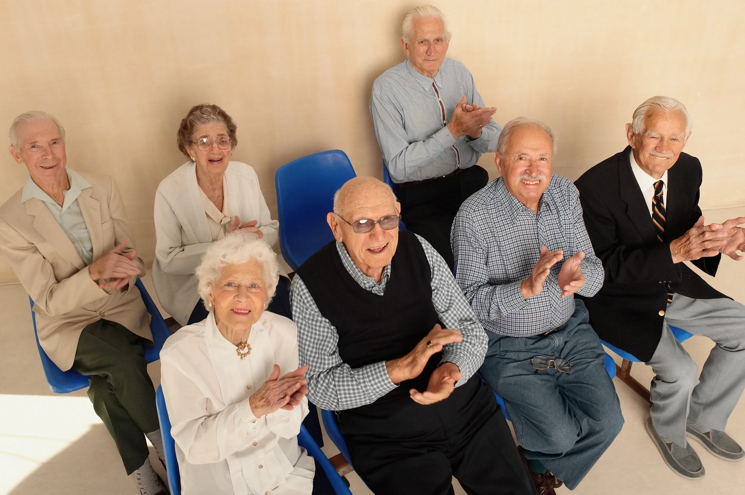 Elderly people looking up applauding